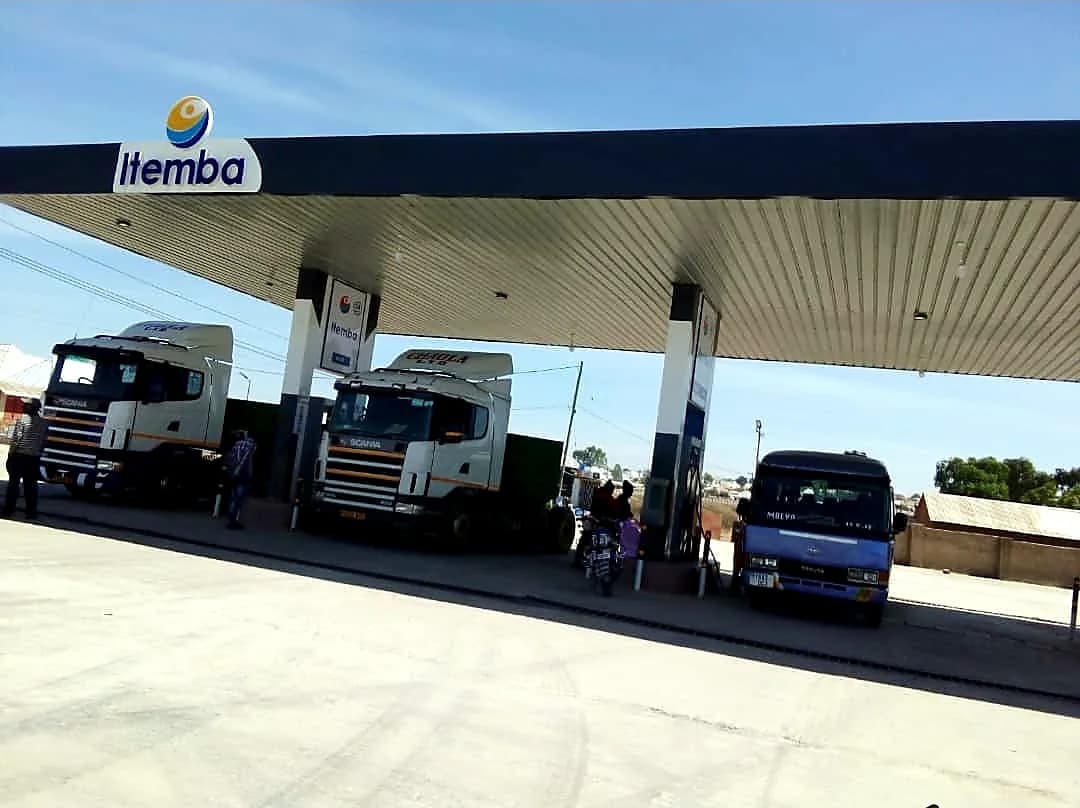 Trucks refuelling under an ITEMBA filling station canopy managed by Mwanjalisi Oil